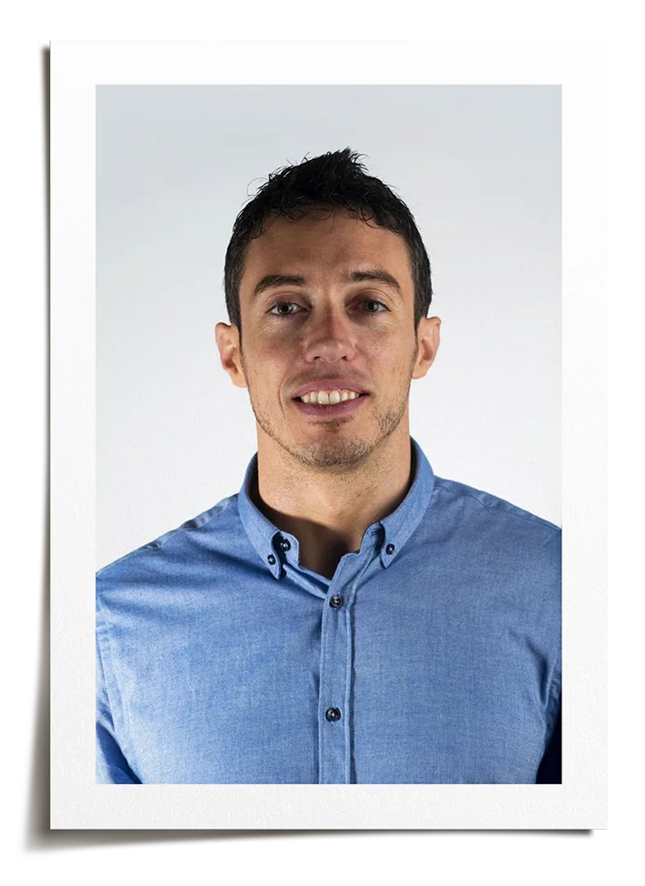 Polaroid-style photo of designer Paolo Inzone wearing a blue, button-down shirt.